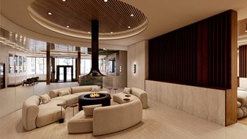 A lobby with couches and chairs and a fireplace